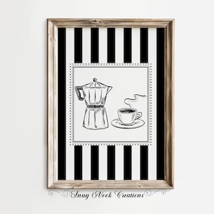 May include: A framed art print with a black and white striped background. The central image is a sketch of a coffee maker and a cup of coffee with steam rising. The frame is light brown. The text "Snug Nook Creations" is at the bottom.