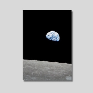 May include: An image of Earth rising over the lunar surface. The Earth is a blue and white sphere against a black background. The foreground shows the gray, textured surface of the moon.