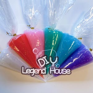 May include: A collection of colorful, glittery slime in clear plastic bags, tied with gold twist ties. The slime colors include white, red, pink, green, blue, and purple. The text "DIY Legend House" is printed on the image.