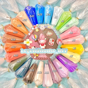May include: A collection of colorful icing bags arranged in a circle, with various shades of pink, orange, green, blue, and purple. The image includes decorative cake toppers and the text "Legendhouse_DIY".