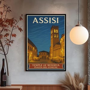 May include: A framed travel poster featuring the Italian city of Assisi. The poster depicts a nighttime scene of the Temple of Minerva and Piazza del Comune, with warm lighting illuminating the buildings and a deep blue sky.