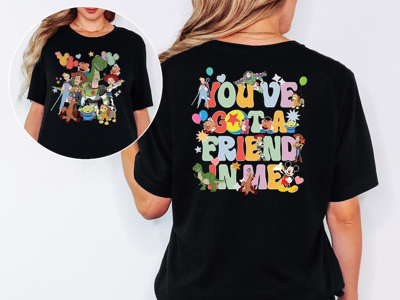 May include: Black t-shirt with a colourful graphic of Toy Story characters on the front and back. The back of the shirt features the text "You've Got A Friend In Me" in a playful font, with character illustrations.