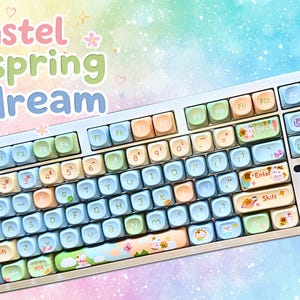 May include: A pastel-colored keyboard with a spring theme. The keys are in shades of blue, green, orange, and yellow. The keyboard has the words "pastel spring dream" in the upper left corner.