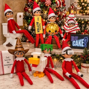 May include: Seven elf dolls in red outfits are arranged in a festive scene. One sits on a toilet, one holds a 4oz Santa's Butter sign, one holds a gold ornament, one is inside a tree cutout, one wears a brown hat, one has a green block head, and one wears white goggles. A sign reads Is It Cake?