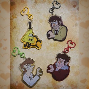 May include: Four character keychains with heart-shaped clasps. The keychains feature cartoon characters in various poses. One keychain is yellow with a top hat and bow tie. The other three keychains feature different characters with glasses and various outfits.