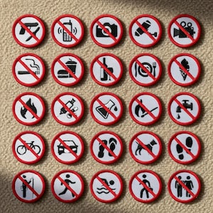 May include: A set of circular patches with red edging and white centres, each displaying a black symbol crossed out with a red diagonal line. Symbols depict various prohibitions, such as smoking, phones, and food.
