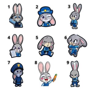 May include: A white ceramic mug with a black handle and the text "But First, Coffee" in a black, handwritten-style font. The mug is on a white surface.