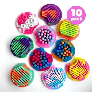 May include: A collection of ten colorful, round silicone products with textured surfaces. Each piece features a unique design with various patterns and colors, including pink, blue, green, orange, and yellow. The products are arranged on a white background.