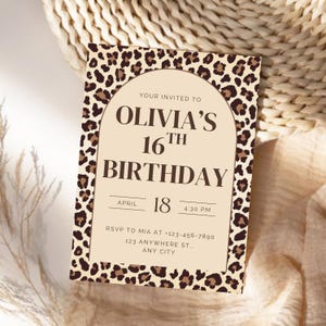 May include: A birthday invitation with a leopard print border. The invitation reads "Olivia's 16th Birthday" with the date and time. The background is a neutral beige color with brown text.