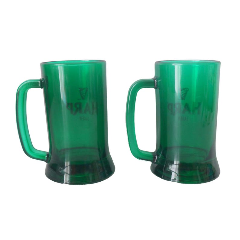 May include: Two green plastic beer tankards with handles. Each tankard features the word "HARP" in black, along with a harp symbol. The tankards are transparent and have a slightly flared base.