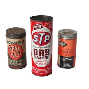 May include: Three vintage metal tins. The center tin is red and white and says "STP Super Concentrated Gas Treatment Add to Gasoline". The tin on the left is brown and says "Bowes Seal Fast Ready Cut Patches". The tin on the right is red and white and says "Gross Bevel-Cut Patch Kit for All Rubber Goods Danger Extremely Flammable".