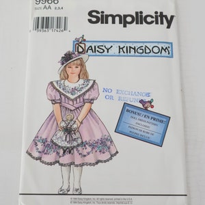 May include: Simplicity sewing pattern featuring a girl in a lavender dress with floral accents, holding a doll. The pattern is for a doll dress and includes the text "DAISY KINGDOM" and "BONUS!/EN PRIME!" on the front.