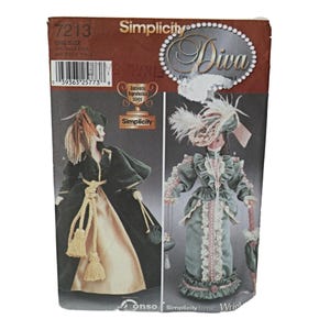 May include: Simplicity pattern number 7213 for a Diva doll. The pattern includes instructions for making two outfits: a green velvet coat with a gold sash and a green lace dress with a white lace collar.