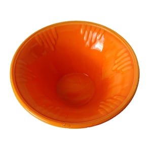 May include: An orange ceramic bowl with a glossy finish. The bowl has a wide, rounded rim and a conical shape, with textured vertical lines on the interior. The bowl is set against a white background.