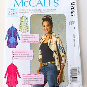 May include: McCall's sewing pattern M7055 for a cardigan with a ruffled hem. The pattern is for sizes X-Small, Small, and Medium. The pattern includes instructions for sewing a set-in sleeve and a curved hem. The pattern is designed for beginners and includes easy-to-follow instructions.