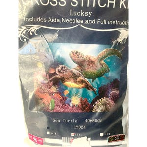 May include: A cross-stitch kit in a clear plastic bag. The kit features a sea turtle design with the text "Sea Turtle" and the dimensions "40*50CM". The kit includes Aida, needles, and instructions. The brand name is Lucksy.
