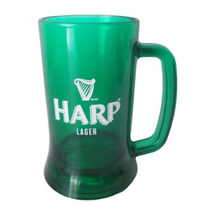 May include: A green plastic beer mug with a handle. The mug displays the Harp Lager logo in white, including a harp symbol. The mug has a wide base and tapers upwards, suitable for beer.