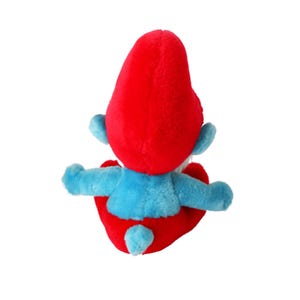 May include: A plush toy of a blue Smurf with a red hat. The Smurf is sitting with its legs crossed and its arms folded. The toy is made of soft, fuzzy fabric.