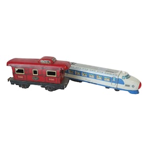 May include: A red and white toy train set with a red passenger car and a blue and white bullet train. The passenger car has the number 556 on it.
