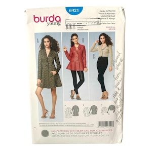 May include: A Burda Young sewing pattern envelope 6921 for a jacket and coat. The front displays three variations: a long dark green coat, a red jacket with a flared hem, and a cropped beige jacket. Includes technical line drawings and size range.