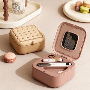 May include: A set of three ceramic mugs with a speckled, matte finish. The mugs are in shades of cream, light gray, and dark gray. Each mug has a simple, minimalist design, perfect for coffee or tea.