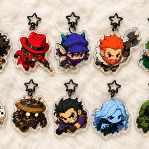 May include: Ten acrylic keychains featuring chibi-style characters with black star-shaped clasps. The designs include various figures with distinct outfits, hair colors, and accessories, such as a red hat, an axe, a playing card, and a green space suit.