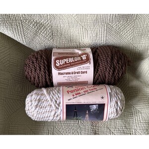 May include: Two skeins of macrame cord. The top skein is dark brown Superlon G texturized polypropylene cord, 7mm by 100 yards. The bottom skein is a white and tan twisted Persian cord, 6mm by 100 yards, made of 100% olefin, colorfast and washable.