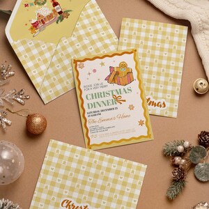 May include: A set of Christmas-themed stationery, including an invitation, two cards, and an envelope. The invitation features a gingerbread man and the text "Christmas Dinner." The stationery has a yellow and white gingham pattern and festive illustrations.