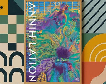 May include: A framed art print with the word "ANNIHILATION" in white vertical text. The artwork features a vibrant, abstract composition with blues, greens, purples, and yellows. The print is in a wooden frame, set against a patterned background.