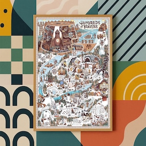 May include: A framed art print featuring a detailed illustrated map with the text "Hundreds of Beavers." The map depicts a whimsical landscape with numerous beavers engaged in various activities, set against a backdrop of mountains, rivers, and forests. The artwork is in a wooden frame.