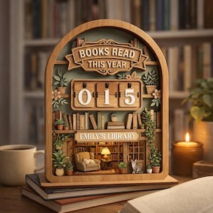 May include: Wooden bookshelf-themed book counter with the text "BOOKS READ THIS YEAR" and "EMILY'S LIBRARY". The counter displays "015" in white numbers. The design includes miniature books, plants, and a cozy reading nook.