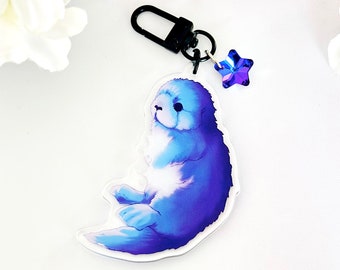 Celestial Sea Otter-sleutelhanger: blauwe acrylbedel met kristallen ster