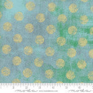 May include: A blue and green fabric with a scattered pattern of small, light yellow circles.