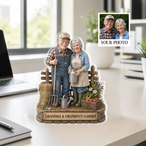 May include: A personalized acrylic garden-themed decoration featuring a smiling elderly couple. The couple is dressed in farmer attire, holding gardening tools and a milk jug. The base reads "Grandma & Grandpa's Garden" with a small photo insert.