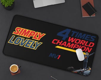 May include: Black rectangular desk mat with the words "SIMPLY LOVELY" in red and yellow, and "4 TIMES WORLD CHAMPION" in blue and red. A photo of a race car driver is on the mat. A computer mouse is on the mat.