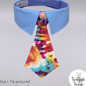 May include: Light blue dog collar with a removable tie. The tie is a colorful tie-dye pattern. The collar has the text "Wiggle Wear" on it. Size L tie pictured with Light Blue collar. Waggle Wear.