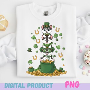 May include: White sweatshirt featuring a St. Patrick's Day design with three cartoon husky dogs stacked on top of each other. The dogs wear green hats, glasses, and scarves, surrounded by shamrocks, horseshoes, and a pot of gold. The words "DIGITAL PRODUCT" and "PNG" are at the bottom.