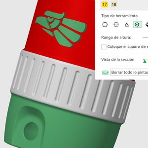 May include: A 3D digital model of a cylindrical object featuring a red top section with a green eagle emblem, a white middle band with vertical ridges, and a green base. A software interface panel is visible on the right with text including Filamentos.