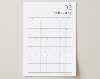 May include: A minimalist white paper calendar for February. The calendar grid is in black, with the days of the week across the top. The month and date, "02 february", are printed at the top. The brand name "paper plans" is at the bottom.