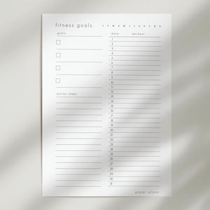 May include: A minimalist white fitness goals planner with the text "fitness goals" at the top. It includes sections for goals, action steps, date, and workout. The planner has a simple, clean design with the text "paper plans" at the bottom.