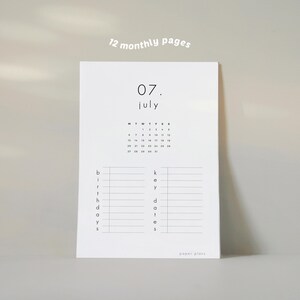 May include: A white paper planner with the month of July displayed. The planner includes a calendar, space for birthdays, and key dates. The text "12 monthly pages" is at the top. The planner is from "paper plans".