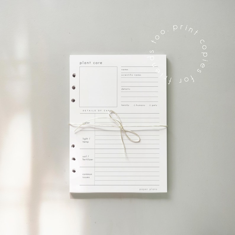 May include: A stack of white plant care sheets tied with twine. Each sheet has a section for plant details, care instructions, and common issues. The text "plant care" and "paper plans" are visible.
