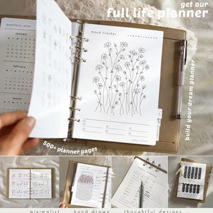 May include: A tan leather-bound planner with a silver ring binder. The planner is open to a mood tracker page with a floral illustration. The text "get our full life planner" and "build your dream planner" are visible.