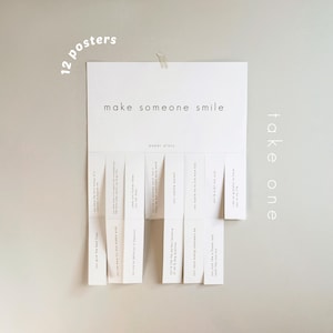 May include: A white paper poster with the words "make someone smile" and "take one" printed on it. The poster has tear-off strips with positive affirmations. The words "12 posters" are printed in the upper left corner.
