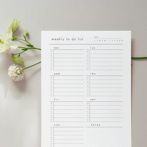 May include: A white weekly to do list planner page with black text and lines. The layout features sections for each day of the week from Monday to Sunday, with a notes section at the bottom. Each day includes five bulleted lines.