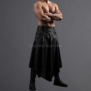 May include: Black leather skirt with decorative metal accents, a high waist, and a flared, asymmetrical hemline. The skirt is paired with matching black boots. The image is set against a gray backdrop.