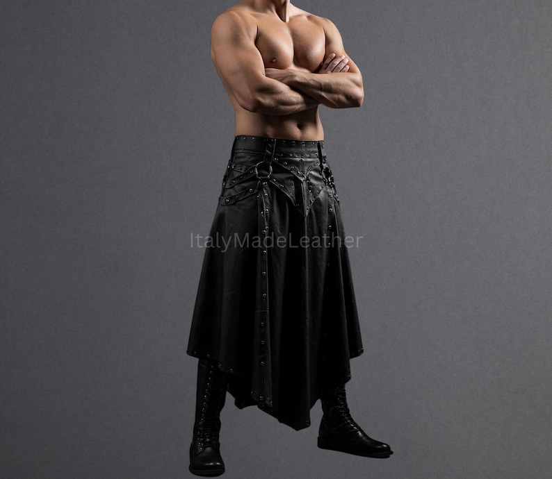 May include: Black leather skirt with decorative metal accents, a high waist, and a flared, asymmetrical hemline. The skirt is paired with matching black boots. The image is set against a gray backdrop.