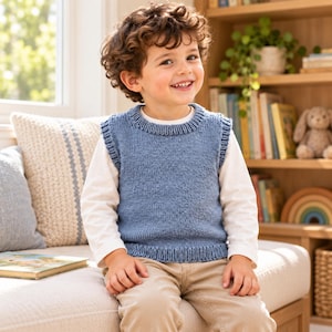 May include: A blue knitted sweater vest featuring a ribbed crew neckline, armholes, and hem. The garment is worn over a long-sleeved white shirt and paired with light-colored trousers, showcasing a simple, textured knit construction throughout.