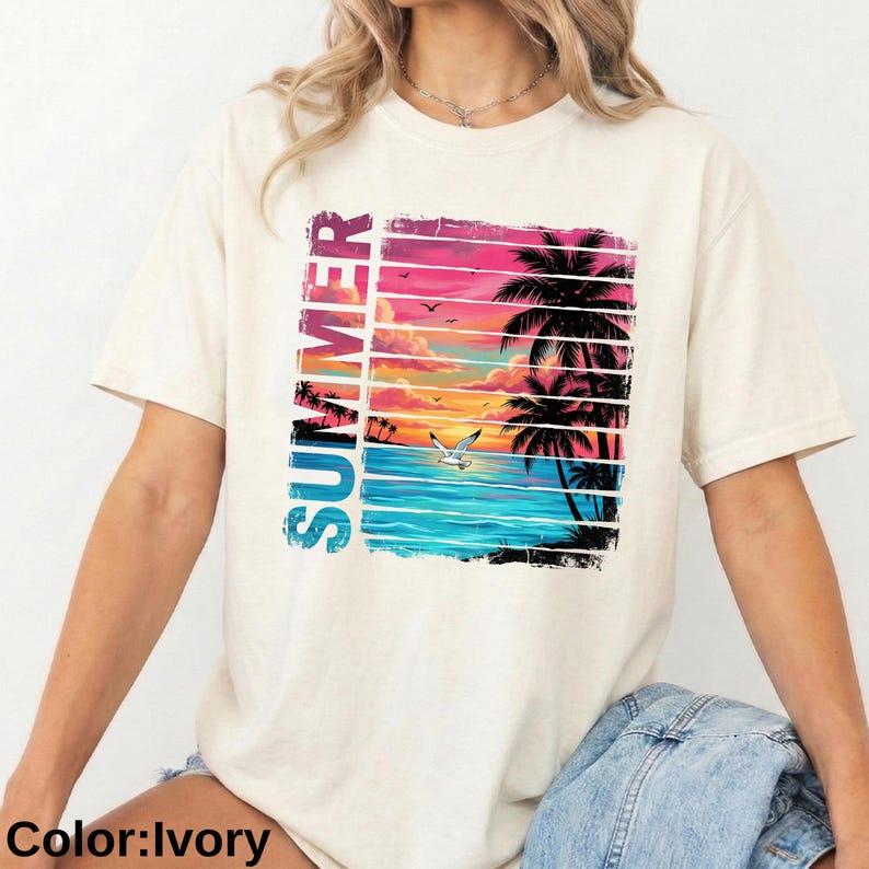 May include: Ivory-colored t-shirt featuring a vibrant summer scene. The graphic includes a sunset over the ocean, palm trees, and a seagull. The word "SUMMER" is printed vertically in blue and pink. The shirt is made of a soft material.