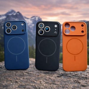 May include: Three phone cases in blue, black, and orange. Each case features a camera aperture and a circular design on the back with a line beneath. The cases are made of a matte material, designed to protect the phone from damage.